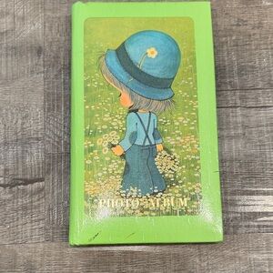 Vintage Green Photo Album with Blue Hat Illustration